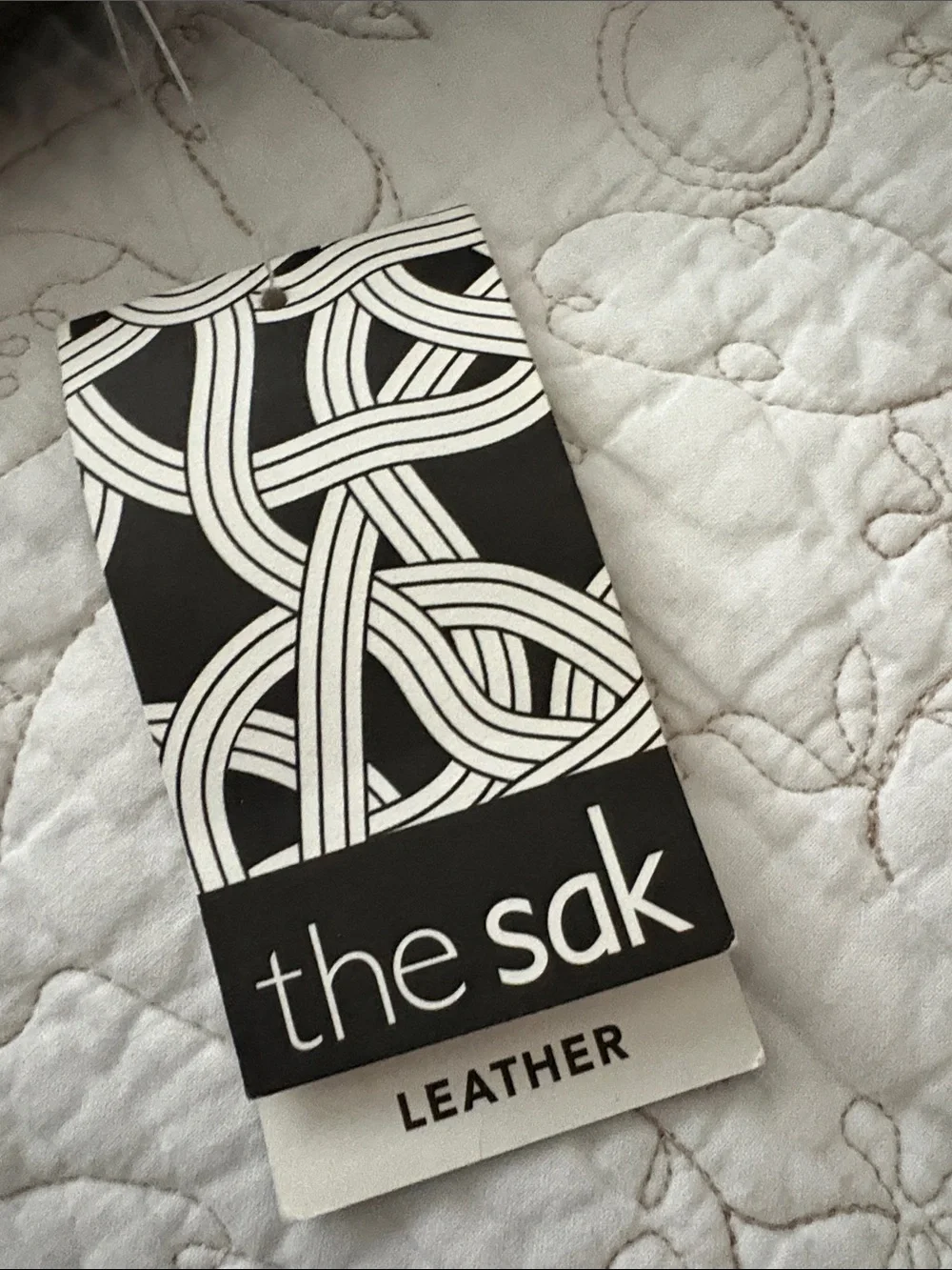 The Sak Leather Messenger Bag in Black and Cream Woven Front